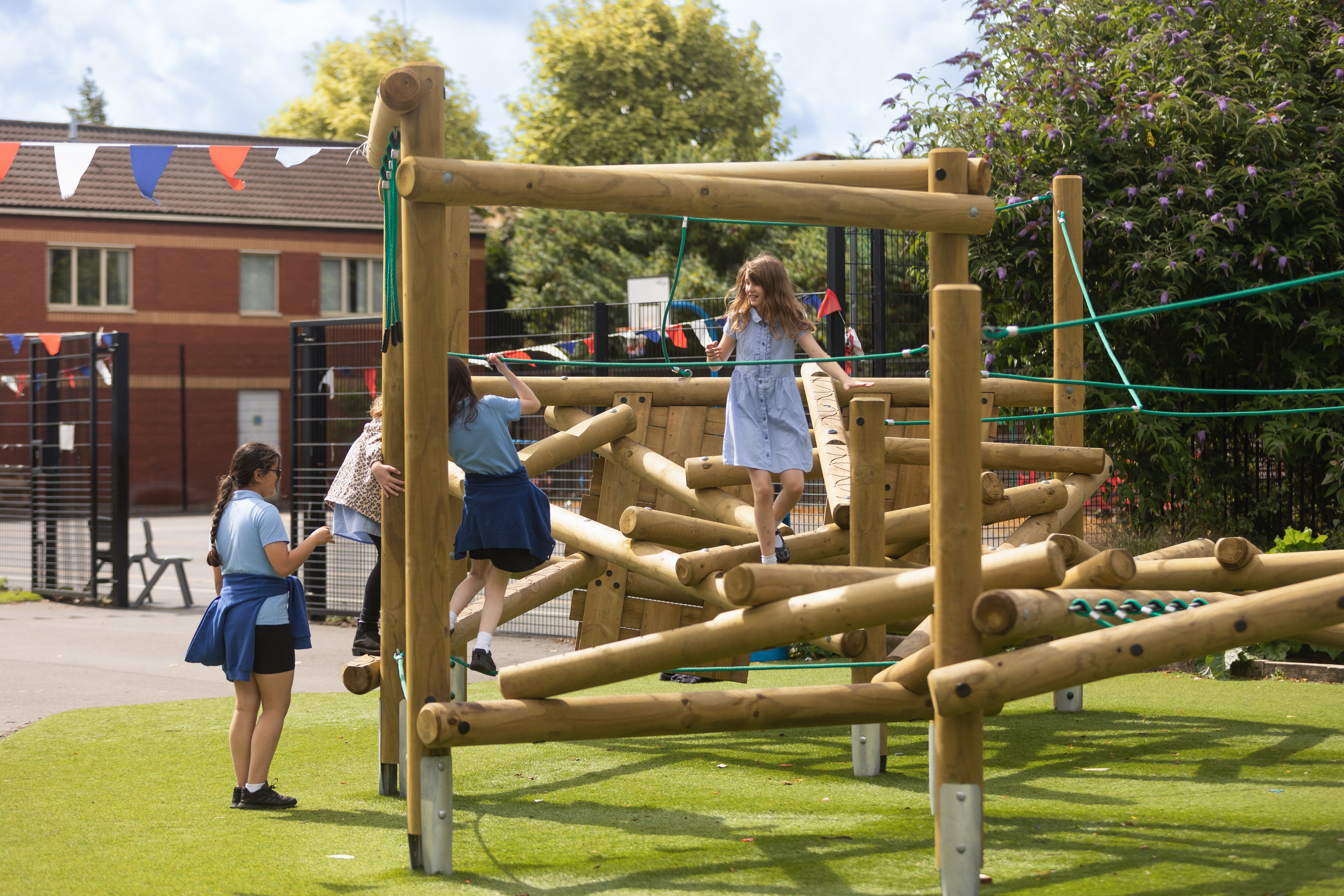 Children on outdoor wooden climbing frame