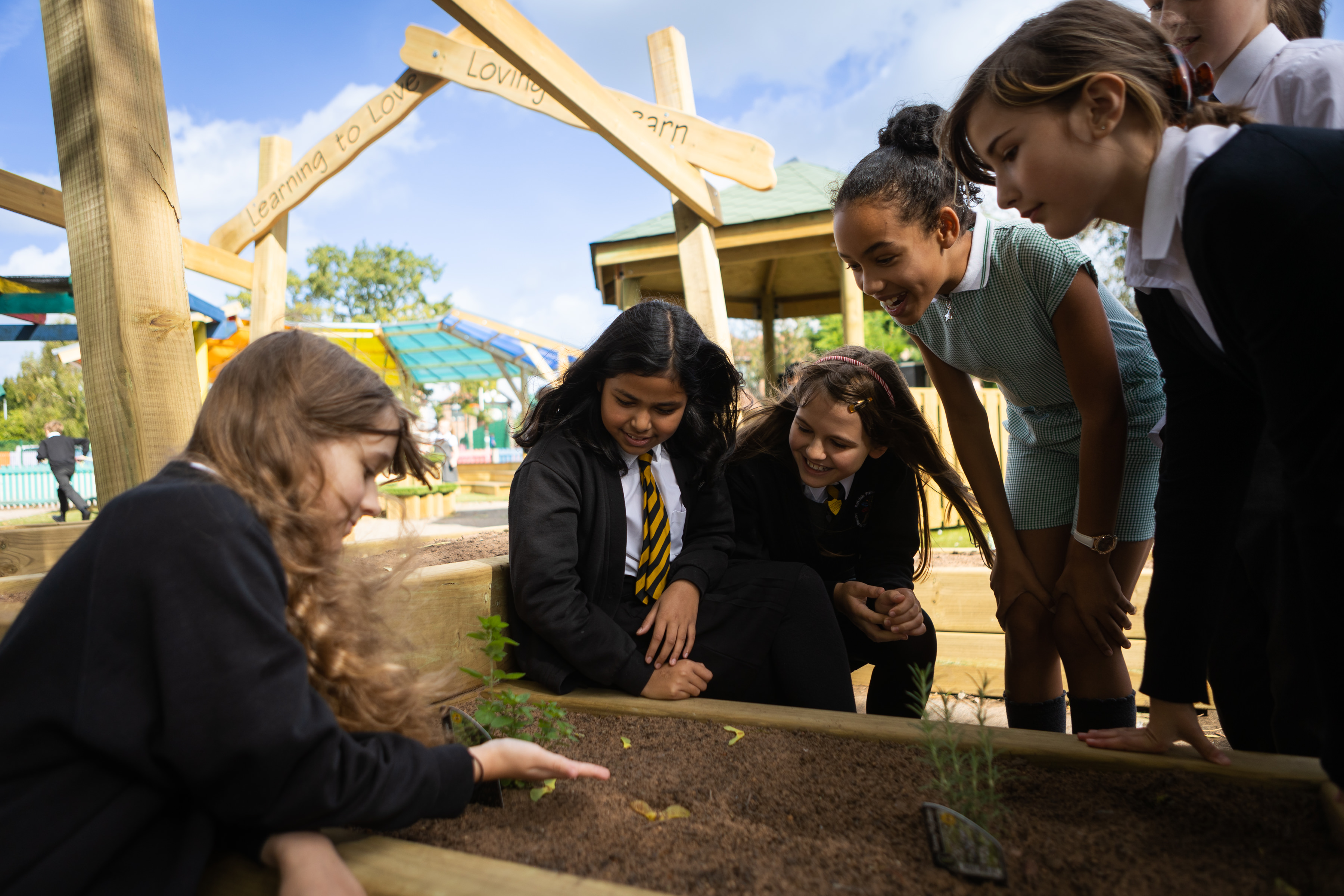 Children looking at planter