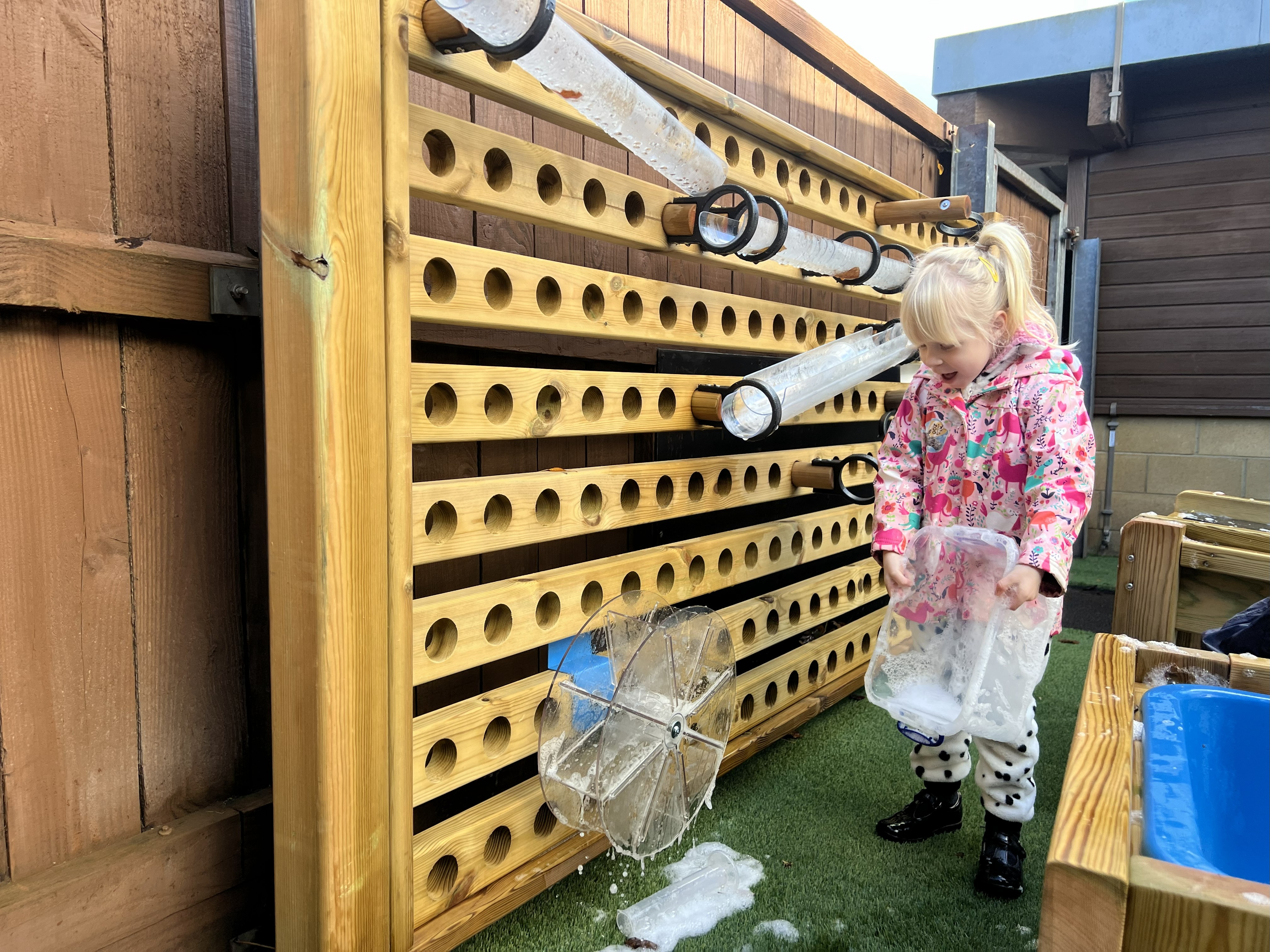 Child playing with water wall