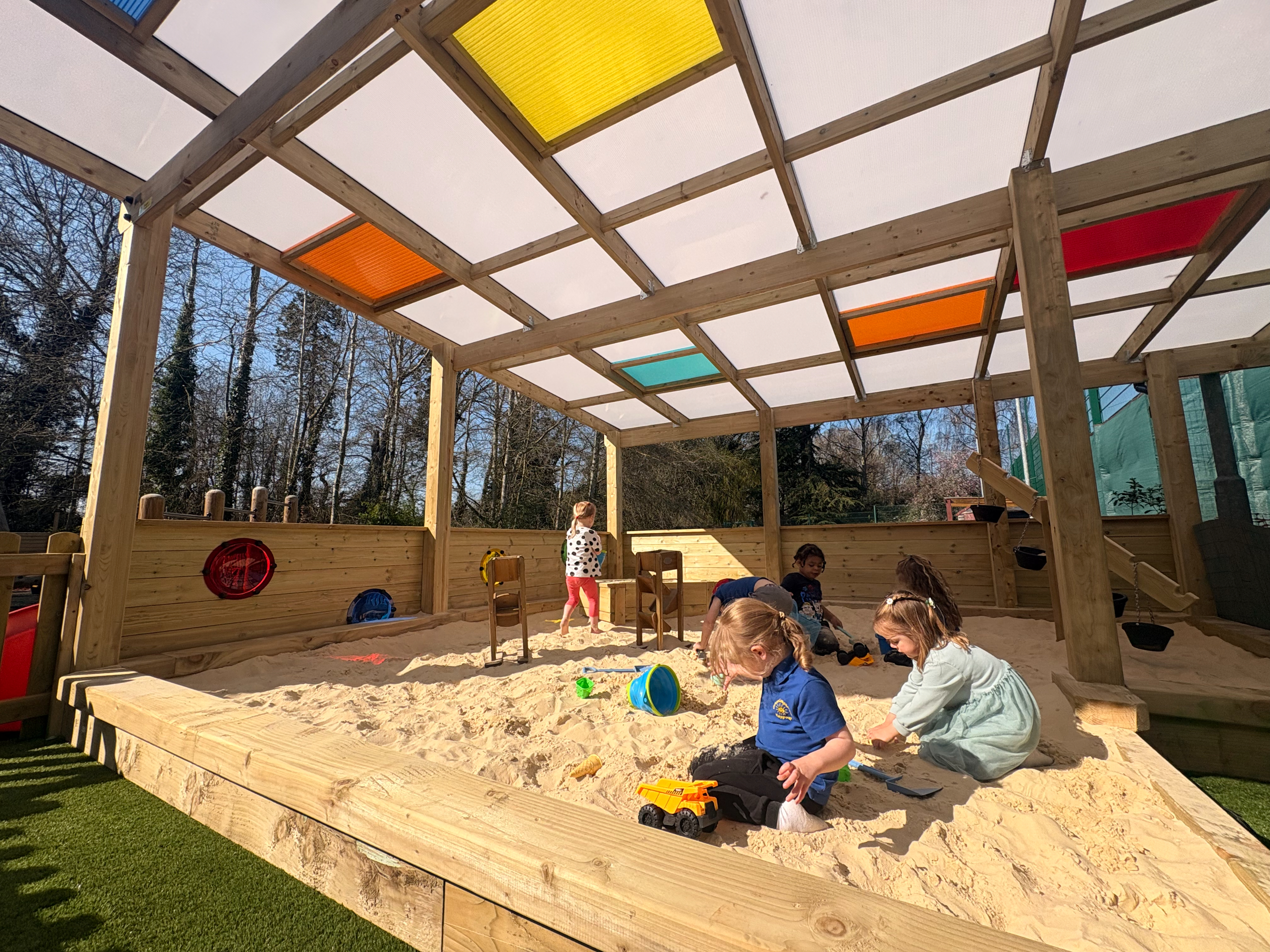 Playground layout ideas: bespoke sandpit with coloured panel insert canopy
