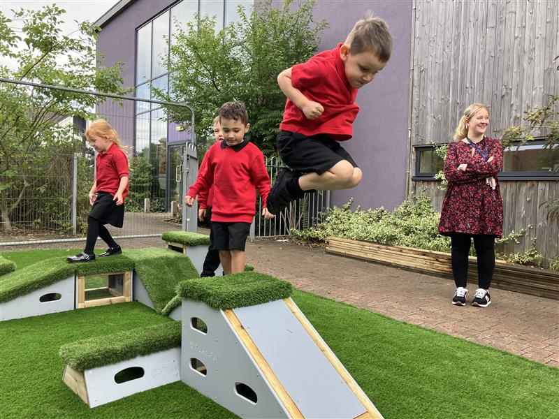 Child using moveable play equipment in a school playground