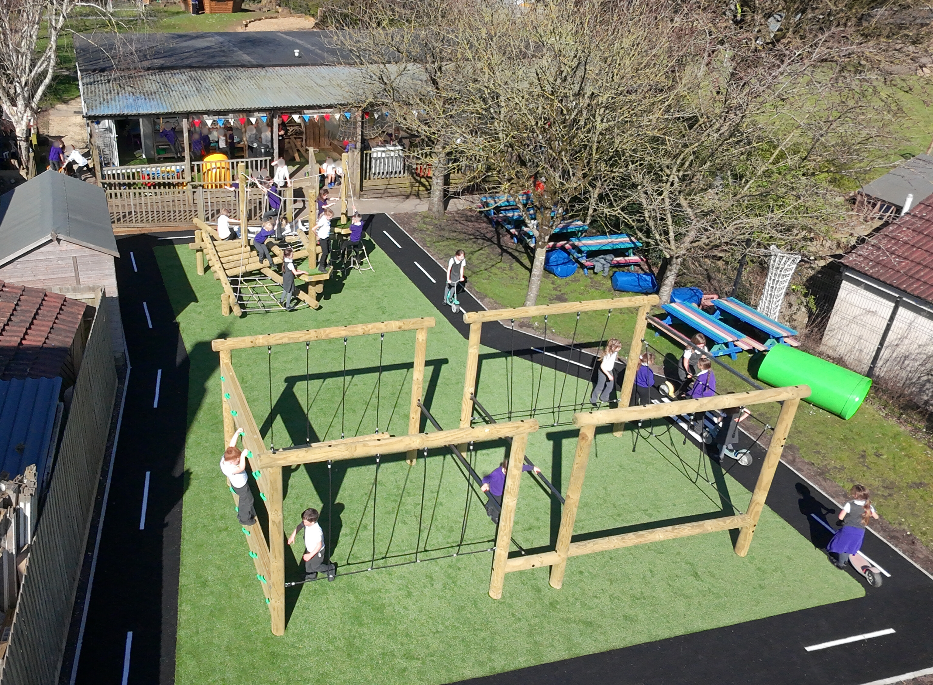 School Playground Development showing children playing on a Lemur Rig, Willow Climber and surrounding roadway